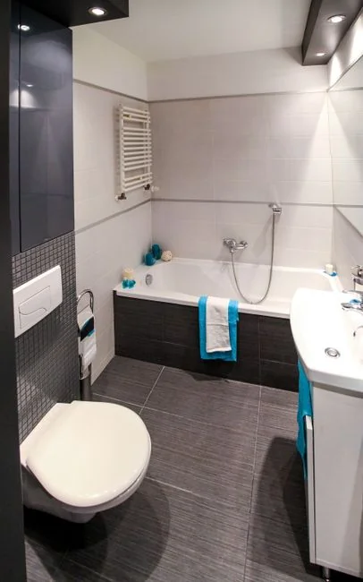 Minimalist room with a person cleaning a chair using a sponge and cleaning product.